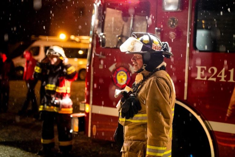 Firefighter at night with water drops falling
