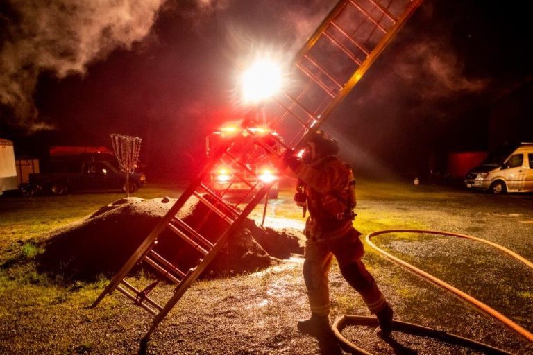 Firefighter repositioning a ladder