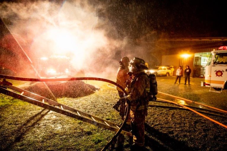 Firefighters at night with water spray in the air